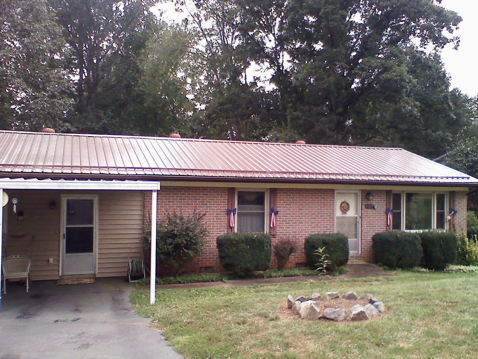 Bronze metal roof and carport on a brick ranch home — Roof Repair work by our crew in Libertyville